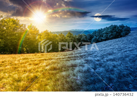 day meet night above carpathian mountain field. view of countryside landscape with valley behind the forest on the hill. sun and moon over clouds on a sky. autumn equinox background for astrology day meet night above carpathian mountain field. view of countryside landscape with valley behind the forest on the hill. sun and moon over clouds on a sky. autumn equinox background for astrology 140736432