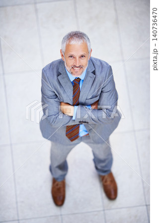 High angle, portrait and happy man with arms crossed in business or office with confidence and pride. Professional, entrepreneur and above person in lobby excited for morning in London at workplace High angle, portrait and happy man with arms crossed in business or office with confidence and pride. Professional, entrepreneur and above person in lobby excited for morning in London at workplace 140736470