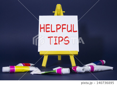 Helpful tips symbol. Wooden blocks with words Helpful tips. Beautiful deep blue background with paints and easel. Business and Helpful tips concept. Copy space. Helpful tips symbol. Wooden blocks with words Helpful tips. Beautiful deep blue background with paints and easel. Business and Helpful tips concept. Copy space. 140736895