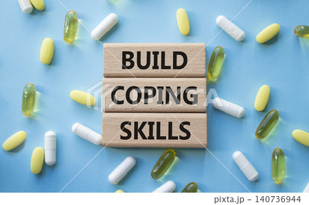 BUILD COPING SKILLS symbol. Concept words BUILD COPING SKILLS on wooden blocks. Beautiful blue background with pills. Healthcare and BUILD COPING SKILLS concept. Copy space. BUILD COPING SKILLS symbol. Concept words BUILD COPING SKILLS on wooden blocks. Beautiful blue background with pills. Healthcare and BUILD COPING SKILLS concept. Copy space. 140736944