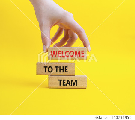 Team symbol. Wooden blocks with words Welcome to the Team. Businessman hand. Beautiful yellow background. Business and Welcome to the Team concept. Copy space. Team symbol. Wooden blocks with words Welcome to the Team. Businessman hand. Beautiful yellow background. Business and Welcome to the Team concept. Copy space. 140736950