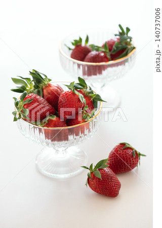 Fresh strawberries in elegant crystal dessert bowls Fresh strawberries in elegant crystal dessert bowls 140737006