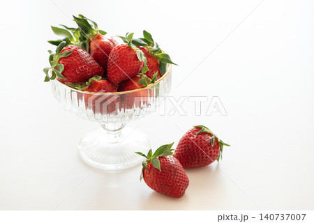 Fresh red strawberries in glass dessert bowl on white background Fresh red strawberries in glass dessert bowl on white background 140737007