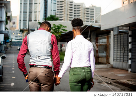 beautiful young couple walking on the street 140737031