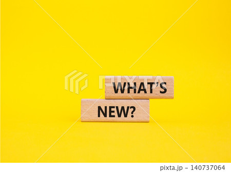 What is new symbol. Concept word What is new on wooden blocks. Beautiful yellow background. Business and What is new concept. Copy space What is new symbol. Concept word What is new on wooden blocks. Beautiful yellow background. Business and What is new concept. Copy space 140737064