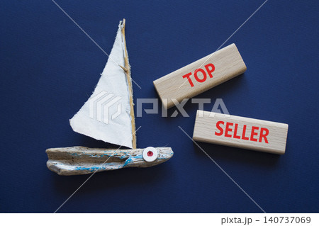 TOP SELLER symbol. Concept word TOP SELLER on wooden blocks. Beautiful deep blue background with boat. Business and TOP SELLER concept. Copy space TOP SELLER symbol. Concept word TOP SELLER on wooden blocks. Beautiful deep blue background with boat. Business and TOP SELLER concept. Copy space 140737069