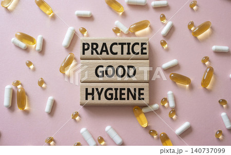 PRACTICE GOOD HYGIENE symbol. Concept words PRACTICE GOOD HYGIENE on wooden blocks. Beautiful pink background with pills. Healthcare and PRACTICE GOOD HYGIENE concept. Copy space. PRACTICE GOOD HYGIENE symbol. Concept words PRACTICE GOOD HYGIENE on wooden blocks. Beautiful pink background with pills. Healthcare and PRACTICE GOOD HYGIENE concept. Copy space. 140737099