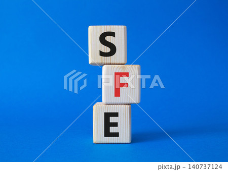 SFE - Sales Force Effectiveness. Wooden cubes with word SFE. Beautiful blue background. Business and Sales Force Effectiveness concept. Copy space. SFE - Sales Force Effectiveness. Wooden cubes with word SFE. Beautiful blue background. Business and Sales Force Effectiveness concept. Copy space. 140737124