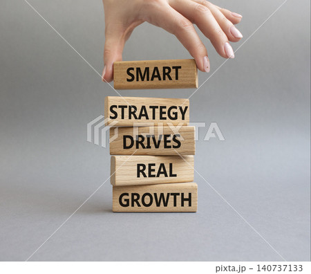 Growth symbol. Wooden blocks with words Smart strategy drives real growth. Businessman hand. Beautiful grey background. Business and Growth concept. Copy space 140737133