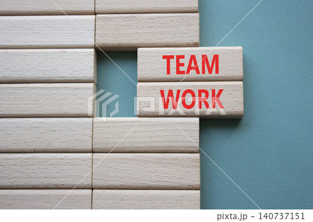 TEAM WORK symbol. Concept word TEAM WORK on wooden blocks. Beautiful grey green background. Business and TEAM WORK concept. Copy space TEAM WORK symbol. Concept word TEAM WORK on wooden blocks. Beautiful grey green background. Business and TEAM WORK concept. Copy space 140737151