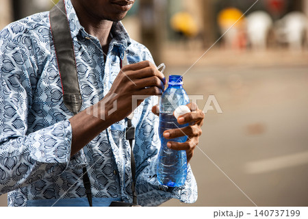 handsome young man tourism drinking mineral water 140737199