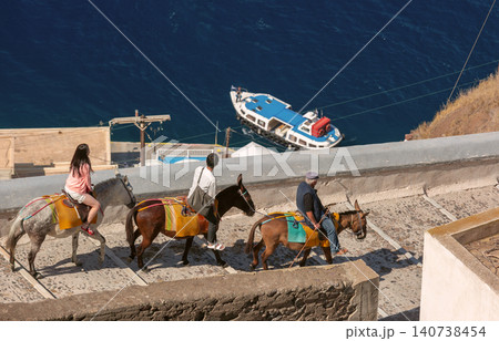 Donkey Ride on Cliff Path Above the Caldera in Santorini Greece Donkey Ride on Cliff Path Above the Caldera in Santorini Greece 140738454