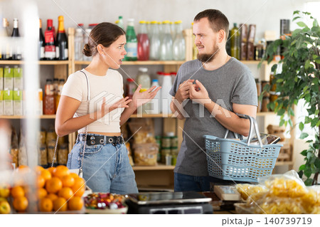 Young man and woman quarreling in grocery store Young man and woman quarreling in grocery store 140739719