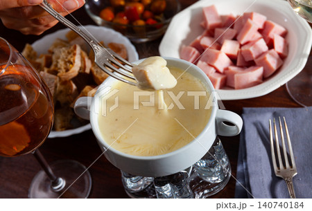 Cheese fondue with bread and snacks Cheese fondue with bread and snacks 140740184