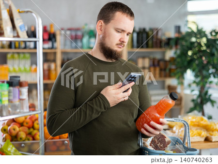 Man scanning grapefruit juice 140740263