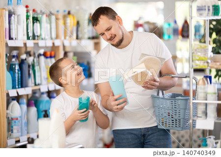 Schoolboy son and dad are choosing bast wisp and shower gel in store Schoolboy son and dad are choosing bast wisp and shower gel in store 140740349