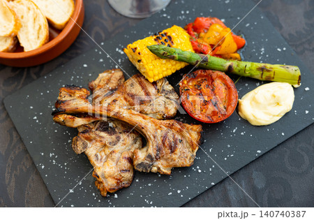 Roast lamb with corn, asparagus and steamed vegetables Roast lamb with corn, asparagus and steamed vegetables 140740387