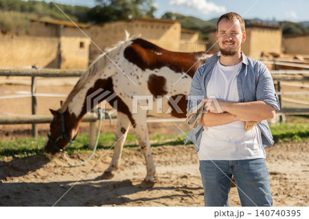 Young man posing in horse paddock 140740395