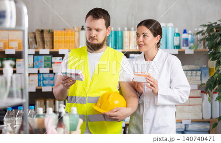 Male builder choosing pills in pharmacy Male builder choosing pills in pharmacy 140740471