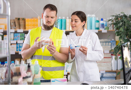 Male builder choosing pills in pharmacy Male builder choosing pills in pharmacy 140740478