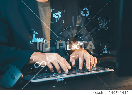 Businessman typing on laptop keyboard with virtual ESG icon representing Environmental, Social and Governance criteria. Businessman typing on laptop keyboard with virtual ESG icon representing Environmental, Social and Governance criteria. 140741412