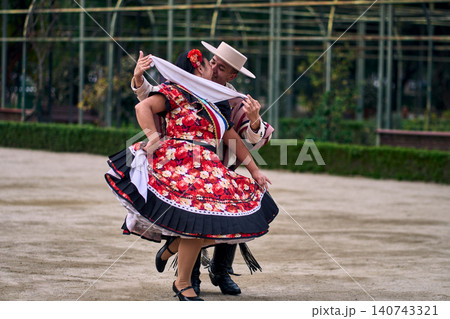 Portrait of a smiling young couple dressed as Chilean huasos, joyfully dancing Portrait of a smiling young couple dressed as Chilean huasos, joyfully dancing 140743321