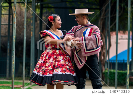 Portrait of a smiling young couple, dressed as Chilean huasos, looking at each other Portrait of a smiling young couple, dressed as Chilean huasos, looking at each other 140743339