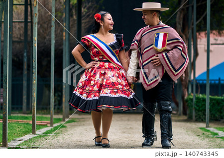 Portrait of a smiling young couple, dressed as Chilean huasos, looking at each other Portrait of a smiling young couple, dressed as Chilean huasos, looking at each other 140743345