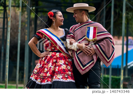 Portrait of a smiling young couple, dressed as Chilean huasos, looking at each other Portrait of a smiling young couple, dressed as Chilean huasos, looking at each other 140743346