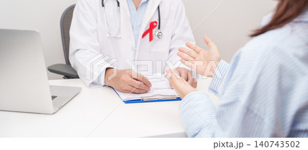 Doctor and patient having a medical consultation for red ribbon concept of December World Aids Day, MADD, October Red ribbon week, February Heart month, Marfan Syndrome, May Stroke awareness 140743502