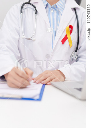 World hepatitis day awareness month, 28 July. doctor using laptop and report notes on notebook. Red and Yellow ribbon for Liver cancer, Jaundice, Cirrhosis, Failure, Enlarged, Hepatic Encephalopathy World hepatitis day awareness month, 28 July. doctor using laptop and report notes on notebook. Red and Yellow ribbon for Liver cancer, Jaundice, Cirrhosis, Failure, Enlarged, Hepatic Encephalopathy 140743580