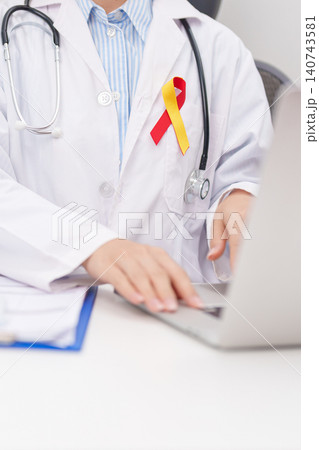 World hepatitis day awareness month, 28 July. doctor using laptop and report notes on notebook. Red and Yellow ribbon for Liver cancer, Jaundice, Cirrhosis, Failure, Enlarged, Hepatic Encephalopathy World hepatitis day awareness month, 28 July. doctor using laptop and report notes on notebook. Red and Yellow ribbon for Liver cancer, Jaundice, Cirrhosis, Failure, Enlarged, Hepatic Encephalopathy 140743581