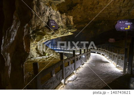 Winding stone path in the famous huge Yellow Dragon Cave in the mountains near Zhangjiajie, China Winding stone path in the famous huge Yellow Dragon Cave in the mountains near Zhangjiajie, China 140743621