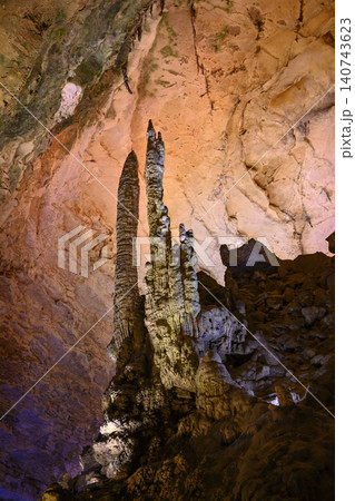 Stalactites and stalagmites colored by light in huge Yellow Dragon Cave near Zhangjiajie, China Stalactites and stalagmites colored by light in huge Yellow Dragon Cave near Zhangjiajie, China 140743623