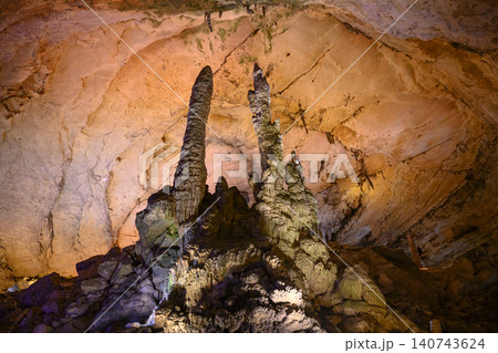 Stalactites and stalagmites colored by light in huge Yellow Dragon Cave near Zhangjiajie, China 140743624