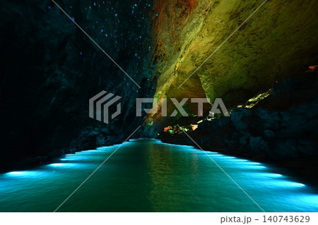 Underwater river illuminated by colored light in Yellow Dragon Cave near Zhangjiajie, China Underwater river illuminated by colored light in Yellow Dragon Cave near Zhangjiajie, China 140743629