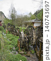 Wooden water wheel system on a stream in Yellow Dragon Park in the mountains near Zhangjiajie, China 140743697