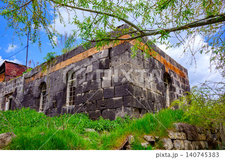 Historic stone structure with arched openings, surrounded by greenery Historic stone structure with arched openings, surrounded by greenery 140745383