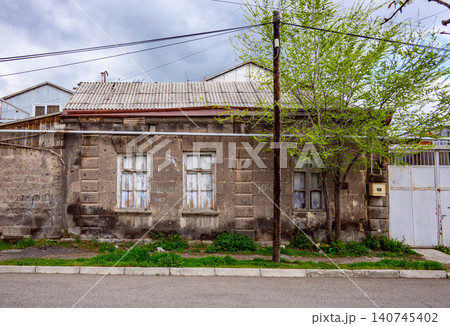 Rustic abandoned building with cracked windows and faded paint 140745402