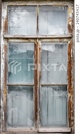 Weathered window in old stone building with blue glass and moss Weathered window in old stone building with blue glass and moss 140745417