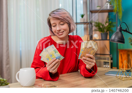 Woman happily counting euro cash money, smiling, satisfied financial success and wealthy emotions Woman happily counting euro cash money, smiling, satisfied financial success and wealthy emotions 140746200