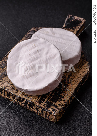 Brie or Camembert cheese is a white, round shape for baking and melting. Camembert cheese 140746453