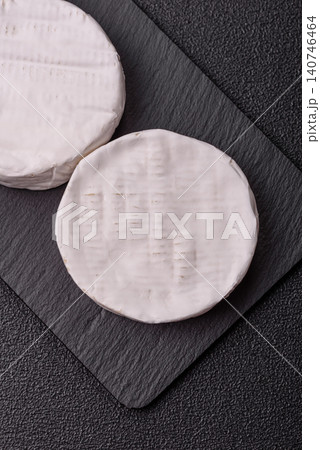 Brie or Camembert cheese is a white, round shape for baking and melting. Camembert cheese Brie or Camembert cheese is a white, round shape for baking and melting. Camembert cheese 140746464