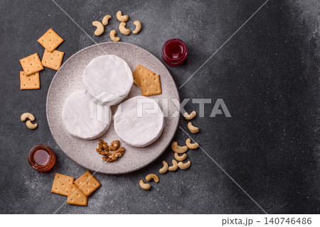 Brie or Camembert cheese is a white, round shape for baking and melting. Camembert cheese 140746486