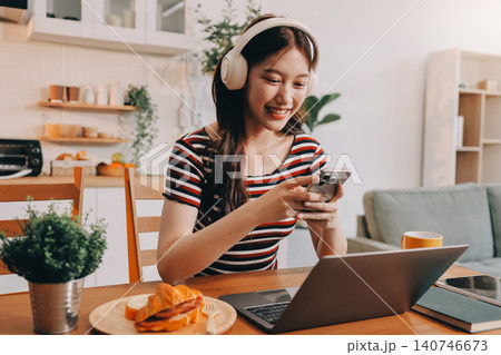 Asian woman using computer remote for business studying, watching online virtual webinar training meeting, video call. asian business woman talking on laptop in home office. Banner, copy space Asian woman using computer remote for business studying, watching online virtual webinar training meeting, video call. asian business woman talking on laptop in home office. Banner, copy space 140746673