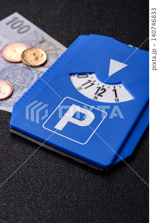 A parking disc, permit, or ticket for measuring time and paying municipal services. A parking disc A parking disc, permit, or ticket for measuring time and paying municipal services. A parking disc 140746833