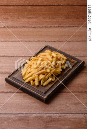 Golden French fries fried with salt and spices, unhealthy takeaway food. French fries 140746953