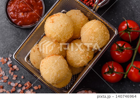 Cheese balls or potato croquettes, golden brown, fried with salt and spices. Cheese balls Cheese balls or potato croquettes, golden brown, fried with salt and spices. Cheese balls 140746964