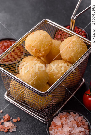 Cheese balls or potato croquettes, golden brown, fried with salt and spices. Cheese balls Cheese balls or potato croquettes, golden brown, fried with salt and spices. Cheese balls 140746965