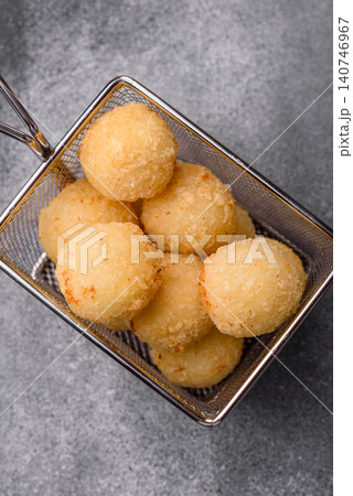 Cheese balls or potato croquettes, golden brown, fried with salt and spices. Cheese balls Cheese balls or potato croquettes, golden brown, fried with salt and spices. Cheese balls 140746967